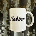 Nyssa Flabben mug with colorful, abstract design, shown from a side view on a plain background.