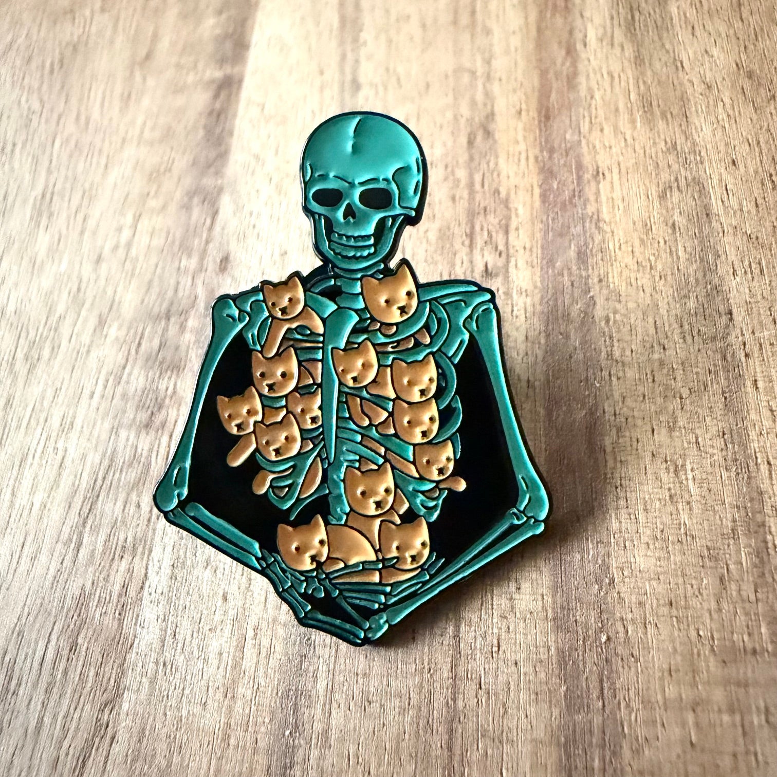 Nyssa kitten pin showing a cute cartoon kitten design with detailed metal craftsmanship, ideal for accessories or collection.