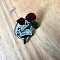 Nyssa Dubble Roses pin featuring a detailed, colorful floral design on a metal pin back.