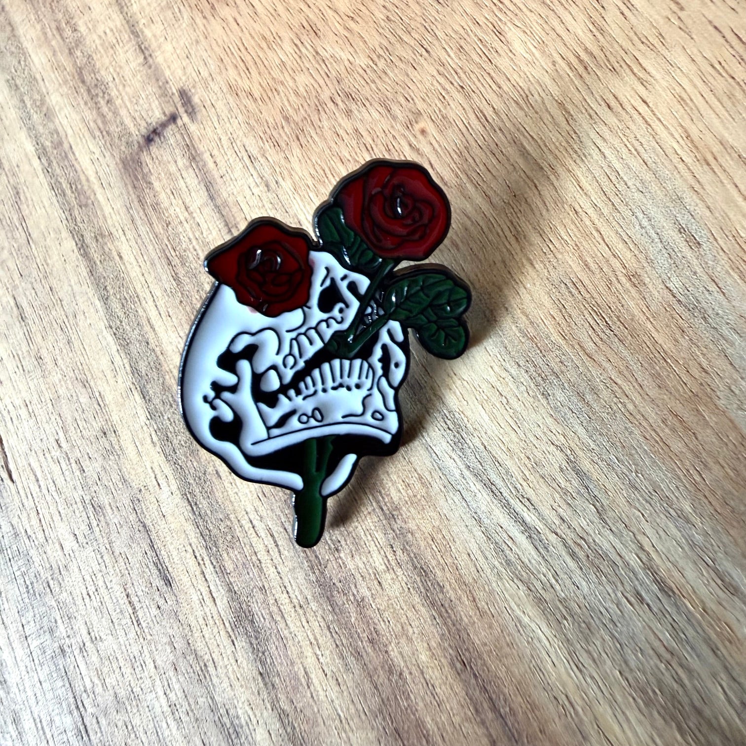 Nyssa Dubble Roses pin featuring a detailed, colorful floral design on a metal pin back.