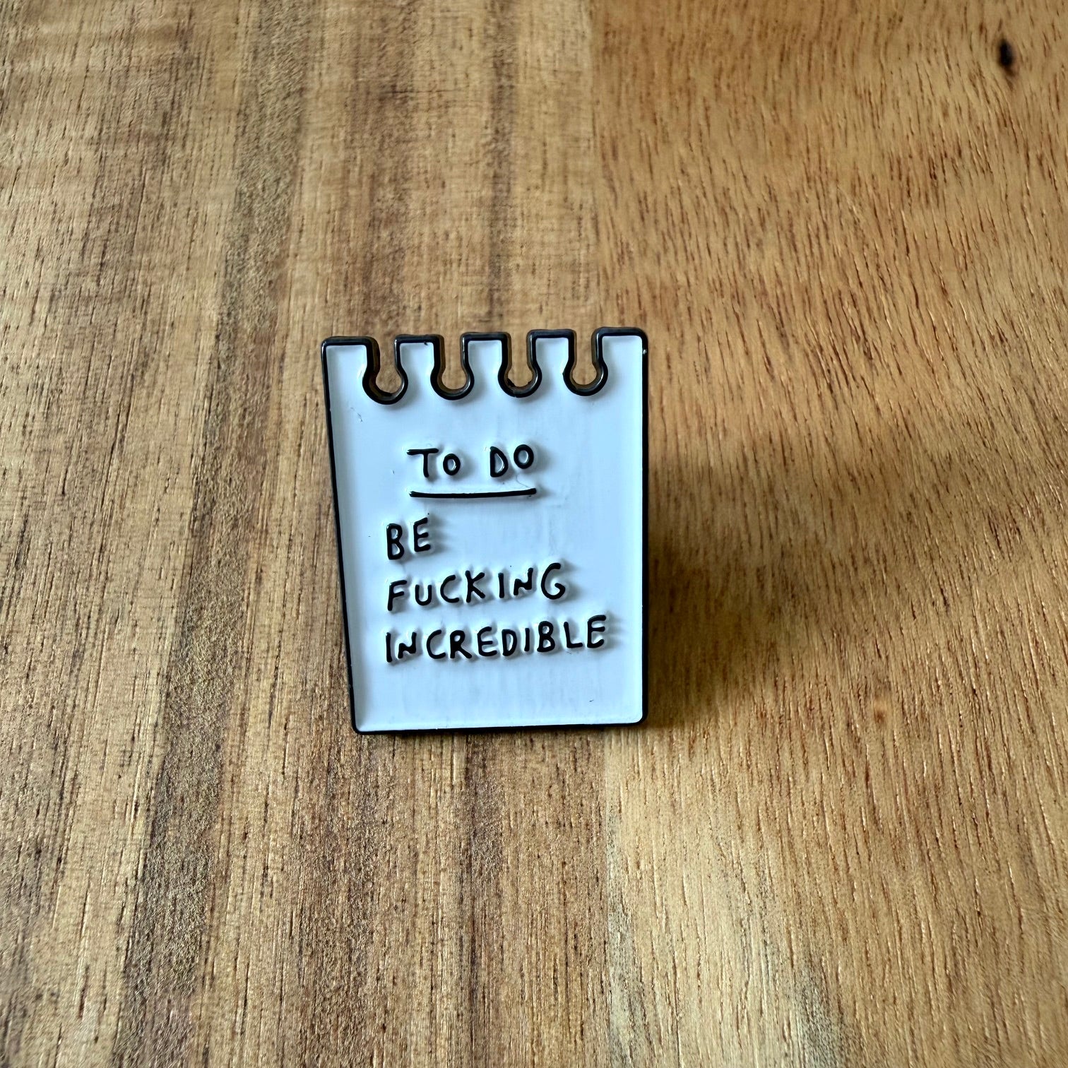Nyssa To Do pin showing a colorful, round pin with "To Do" text, perfect for accessorizing bags or clothing.