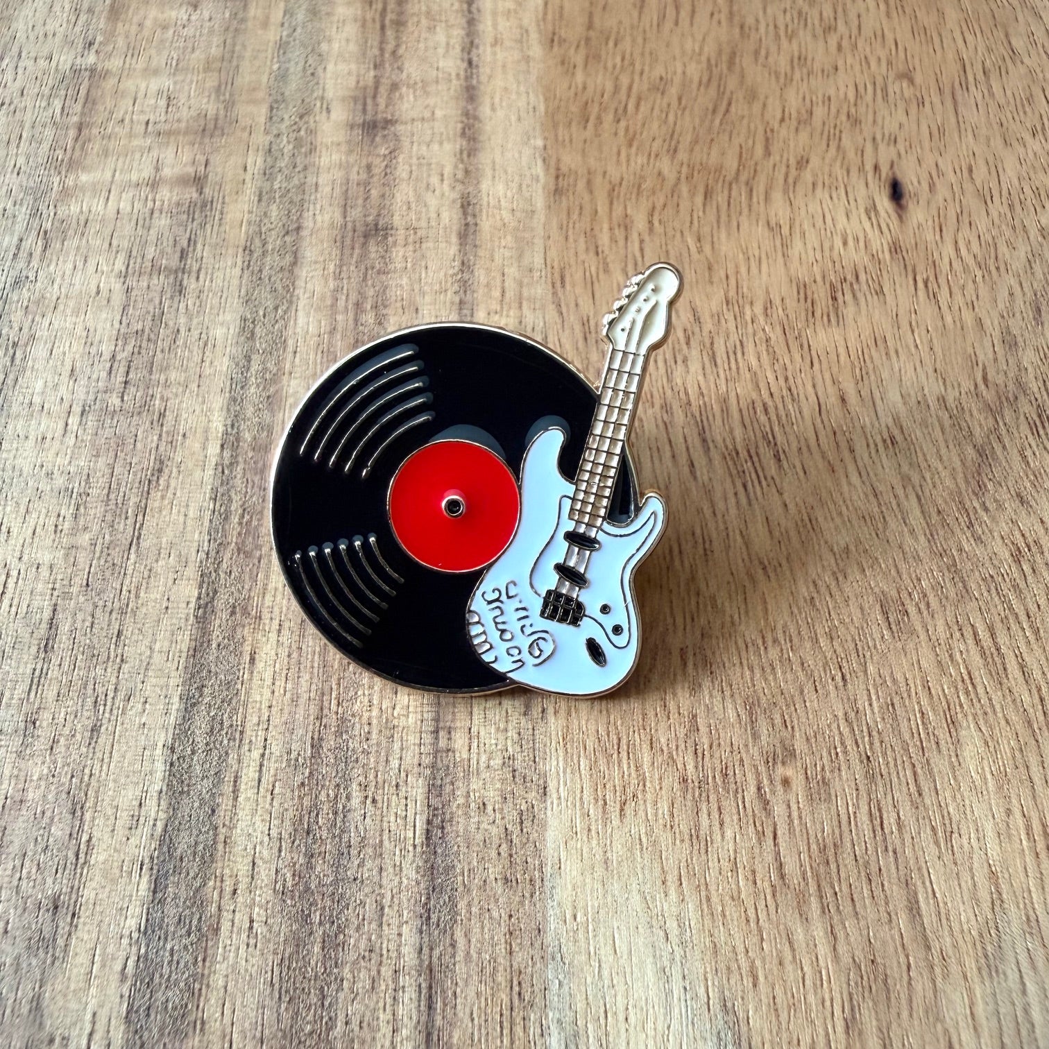 Nyssa record pin featuring a stylish design, perfect for collectors and fashion enthusiasts.
