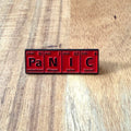Nyssa Panic pin featuring bold design, metal pin back, perfect for jackets or backpacks.