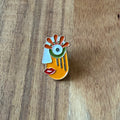 Nyssa Art1 pin featuring a colorful, detailed design on a metal pin backing, perfect for accessories or collection.