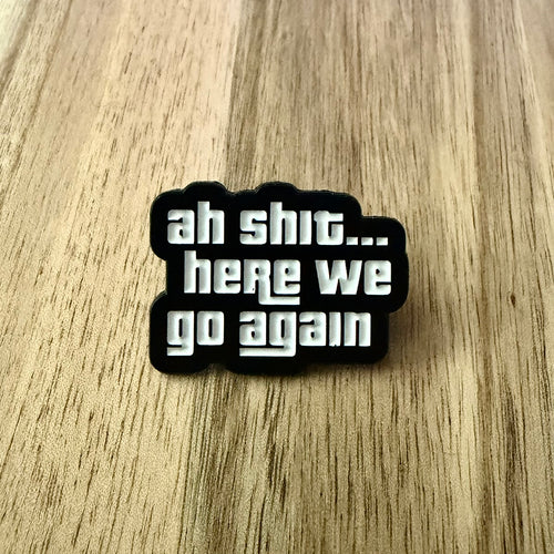 Nyssa "ah shit" pin featuring bold text design, perfect for accessorizing clothing or bags with a humorous touch.