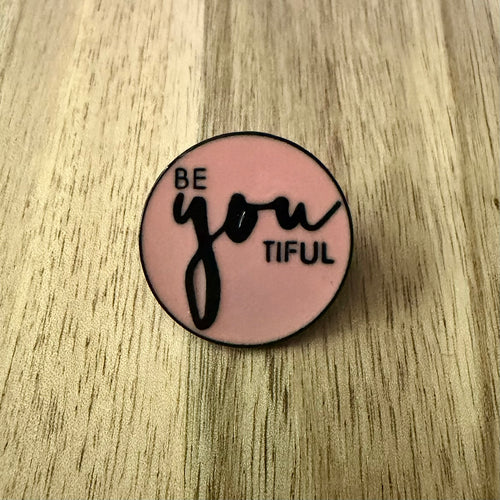 Nyssa "Be you tiful" pin featuring a colorful design, perfect for accessorizing clothing or bags.