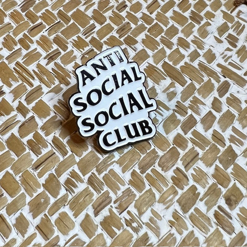 Anti social Nyssa pin featuring bold black and white design, perfect for jackets or backpacks.