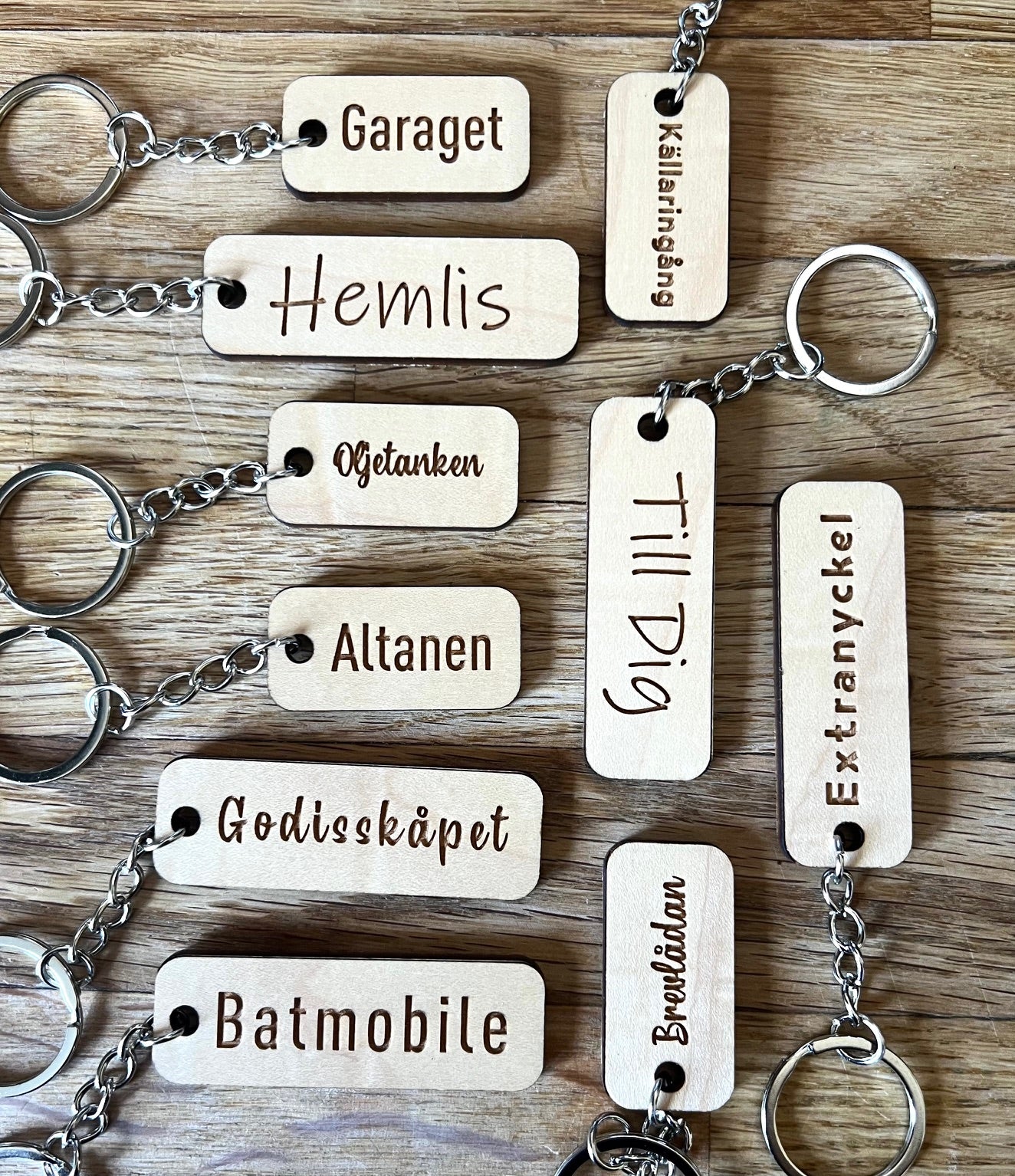 Custom wooden keychain by Nyssa with personalized engraved text on a laminated wood keyring.
