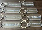 Transparent acrylic keyring with custom engraved text from Nyssa, featuring a sleek and modern design.