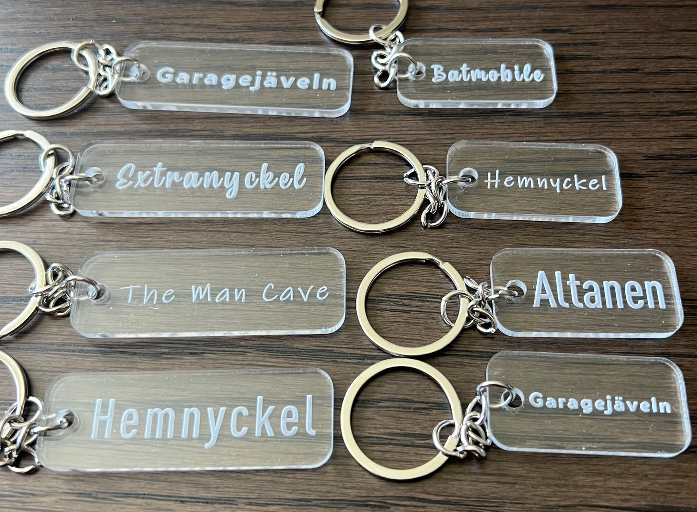 Transparent acrylic keyring with custom engraved text from Nyssa, featuring a sleek and modern design.