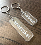 Transparent acrylic keyring with custom engraved text by Nyssa, showcasing a sleek and personalized accessory.