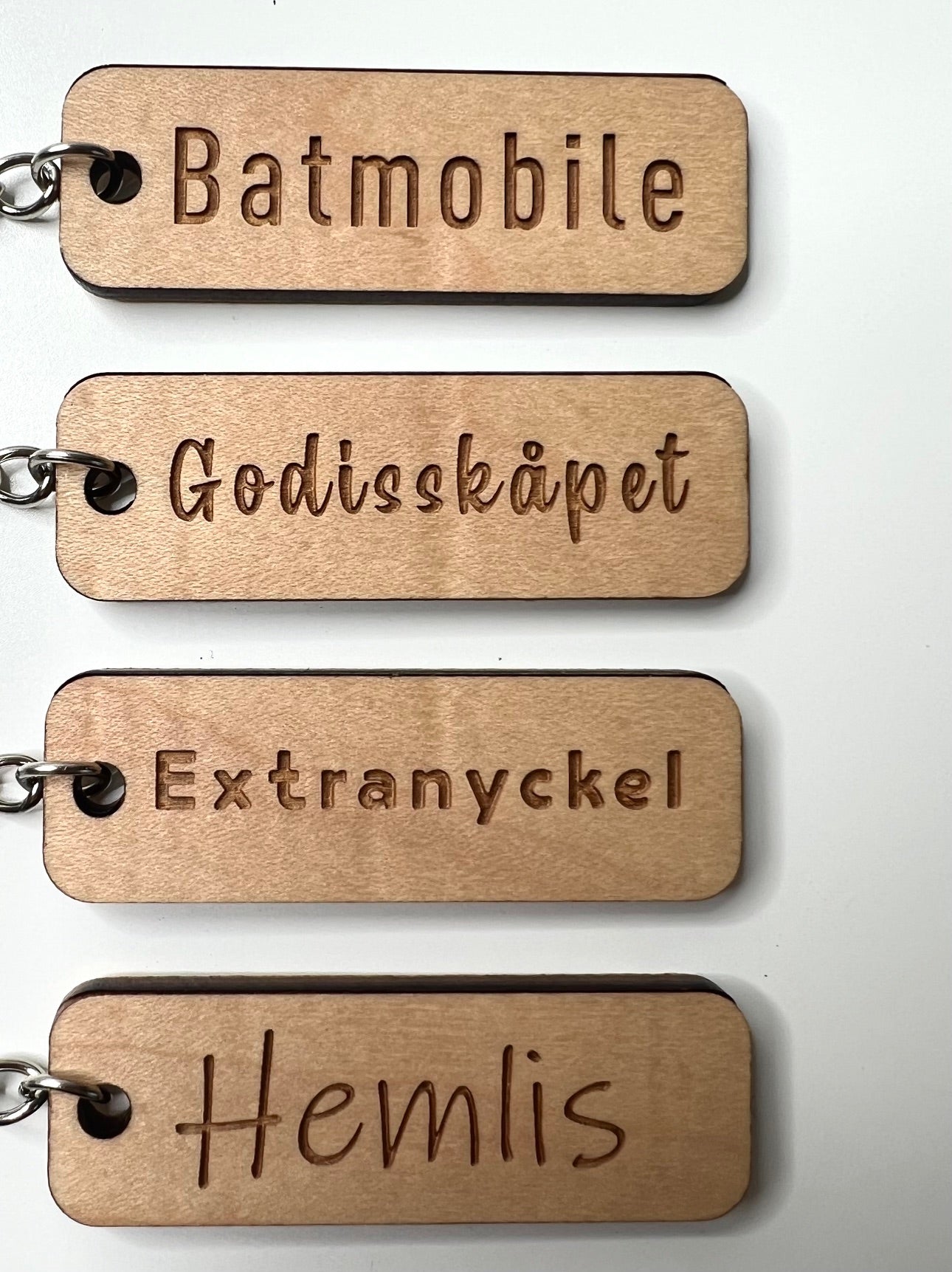 Personalized Nyssa keyring with custom text and wood-laminated design, featuring a sleek and durable keychain style.