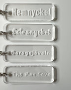 Transparent acrylic keyring from Nyssa with custom engraved text, featuring a sleek and modern design.