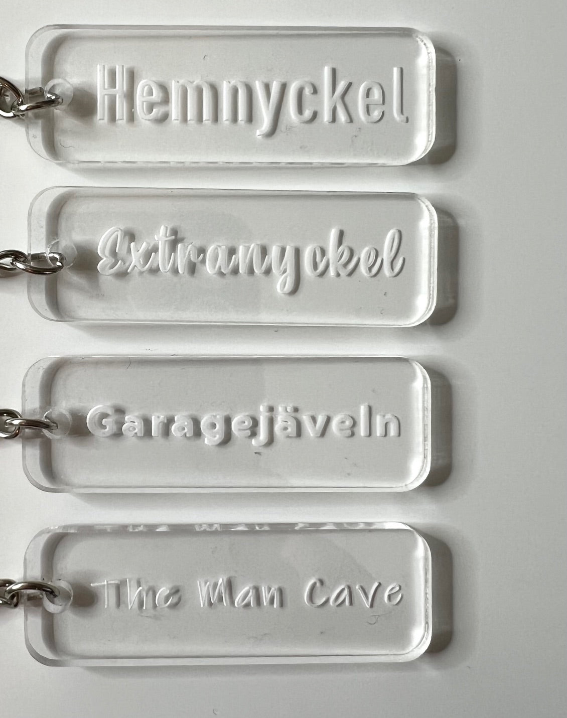 Transparent acrylic keyring from Nyssa with custom engraved text, featuring a sleek and modern design.