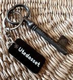 Black acrylic laminated keyring with custom engraved text from Nyssa, showcasing a sleek and personalized accessory.