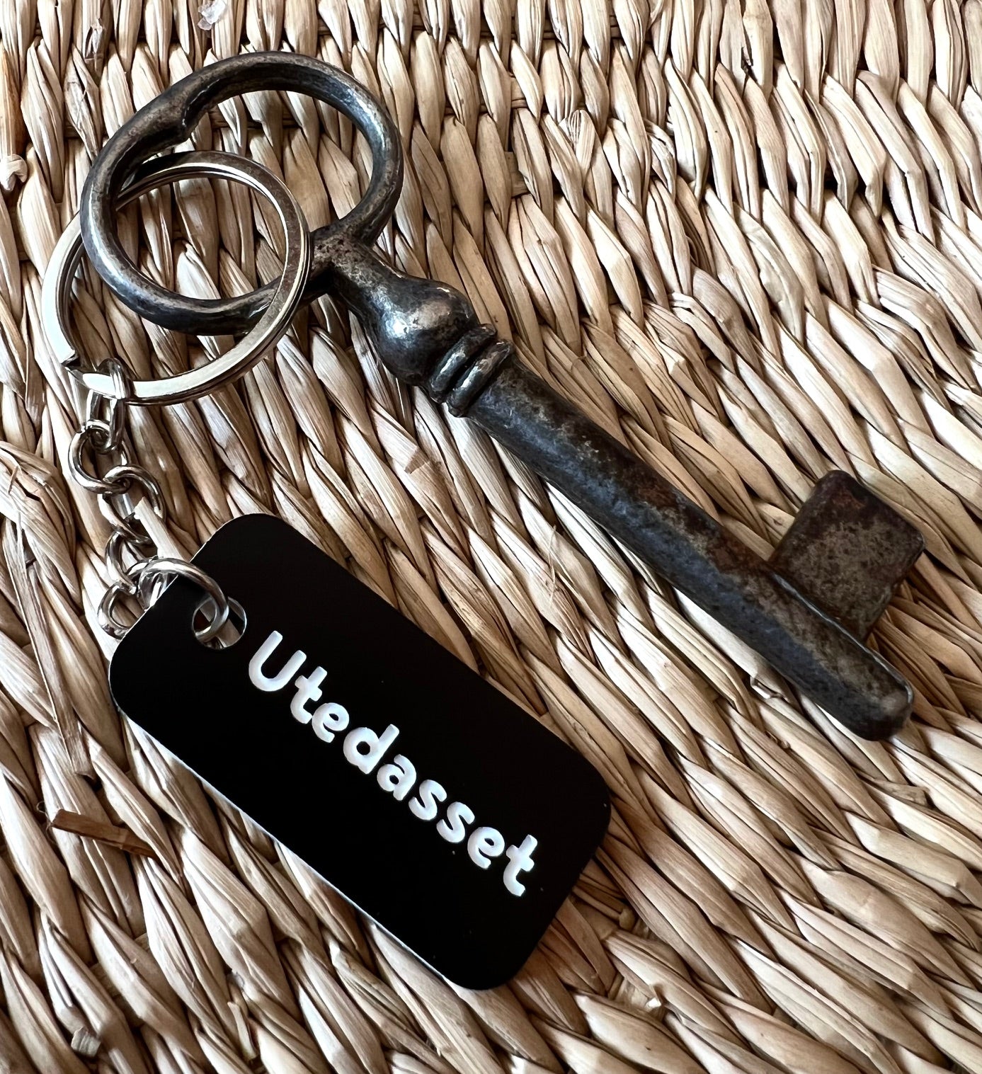 Black acrylic laminated keyring with custom engraved text from Nyssa, showcasing a sleek and personalized accessory.