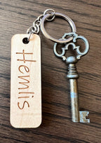 Nyssa custom wooden keychain with engraved personal text, made from wood laminate, displayed on a neutral background.