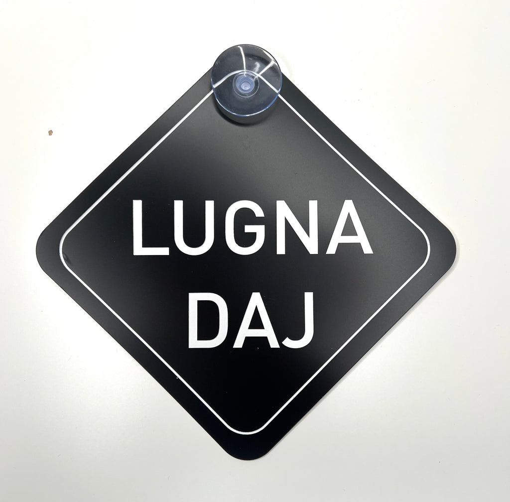 Skånska language car license plate with "Lugna Daj" phrase, branded by Nyssa, mounted on a vehicle.