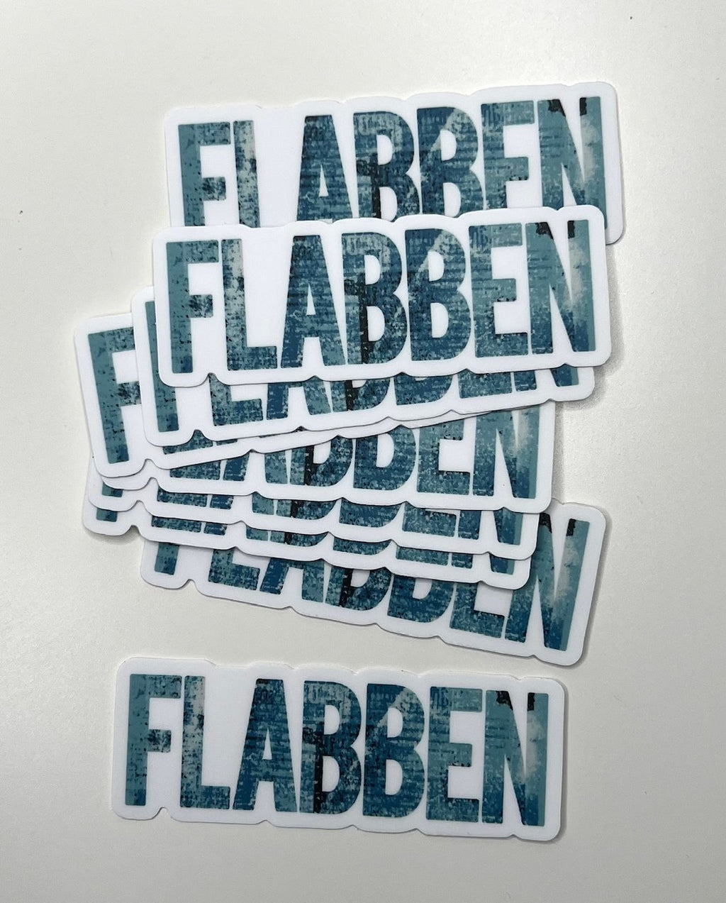 Skånska language sticker by Nyssa featuring the phrase "Säg det på Skånska" on a colorful adhesive sticker.