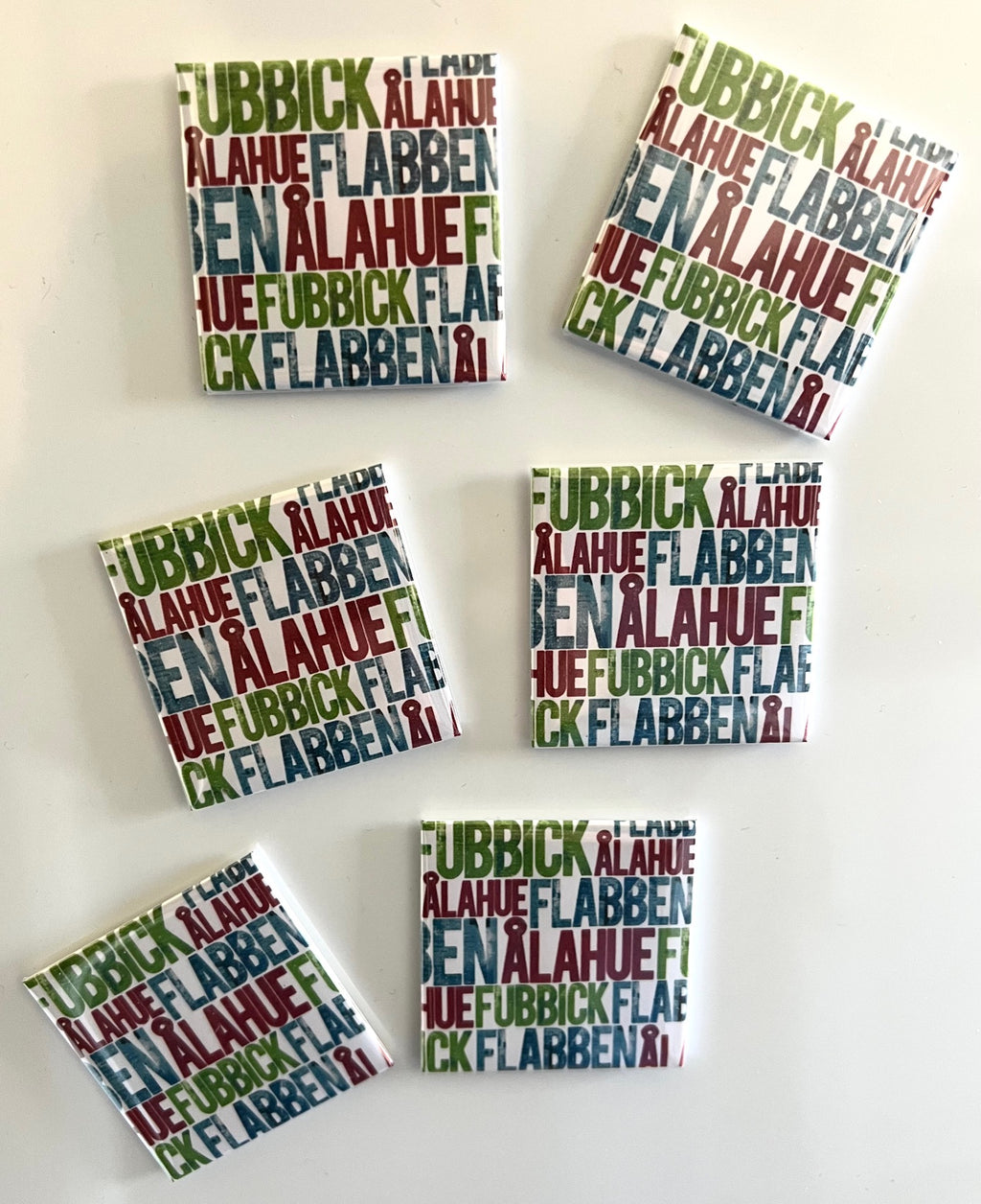 Skånska kylskåpsmagnet with Skånska words, branded by Nyssa, featuring colorful text design on a magnet for refrigerator decoration.