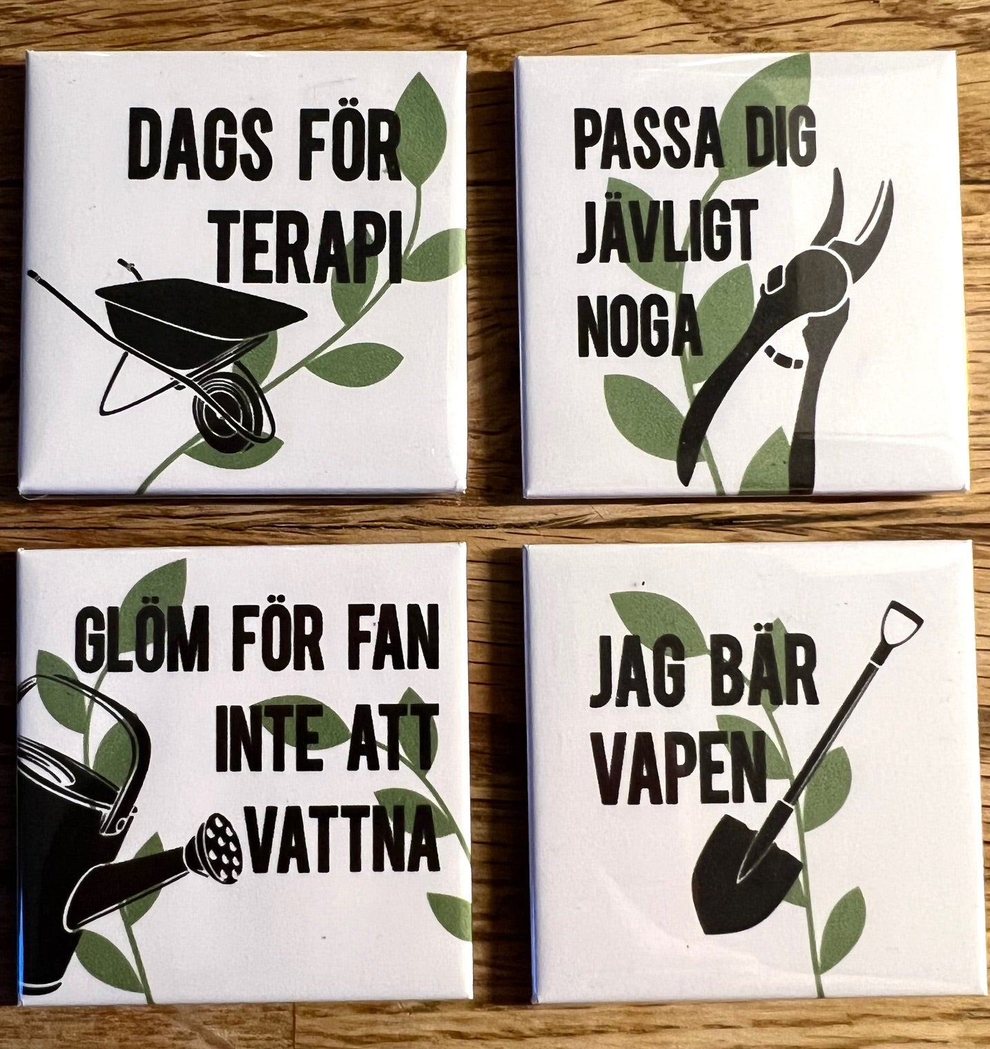 Set of four Nyssa Det våras refrigerator magnets with colorful spring-themed designs on metal surfaces.