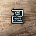 Nyssa "What Goes Around Comes Around" pin featuring a circular design, perfect for accessorizing or collecting.