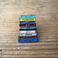Nyssa pin featuring a book design, small metal lapel pin with detailed book illustration, ideal for book lovers or collectors.
