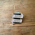 Nyssa Book Nerd pin featuring a colorful literary-themed design, perfect for book lovers and pin collectors.