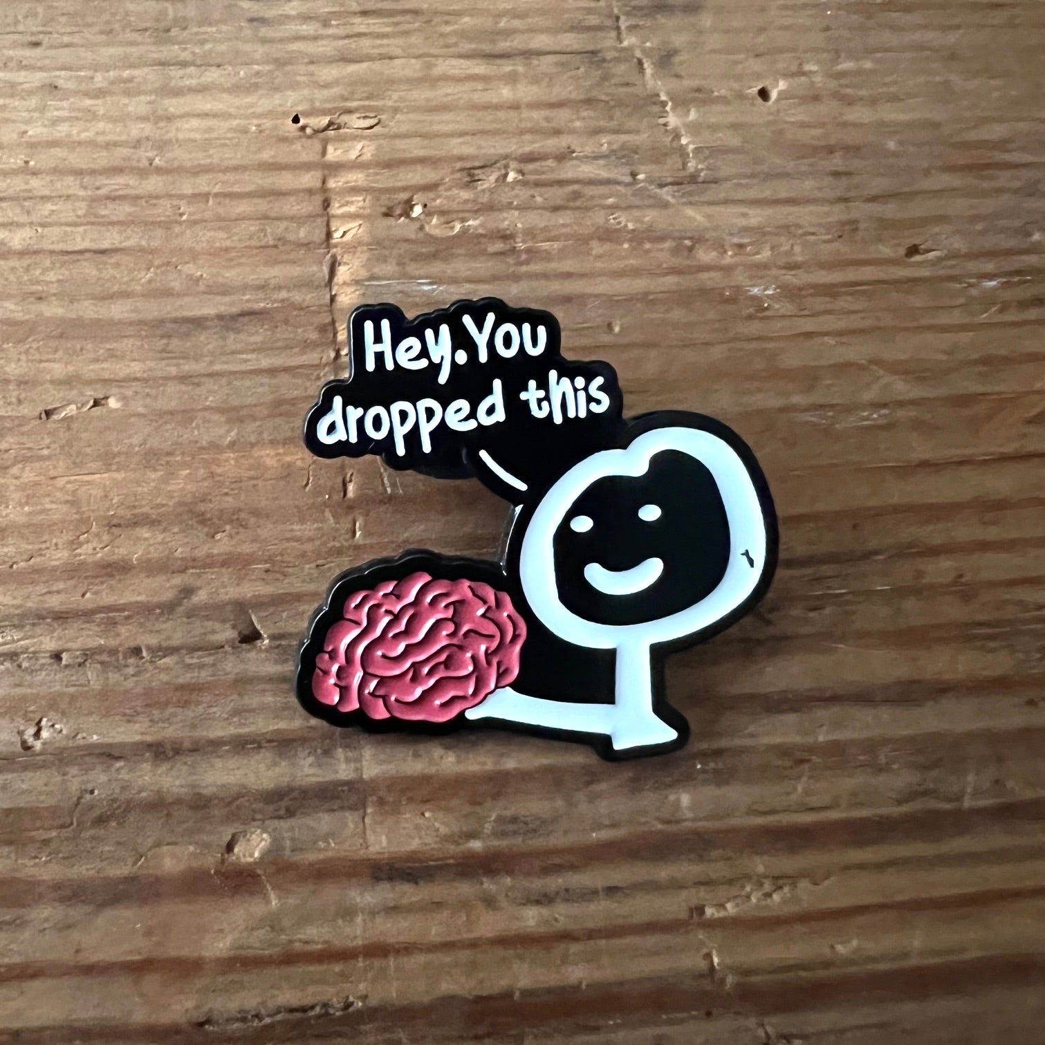 Nyssa "Hey, you dropped this" pin featuring a humorous design, perfect for accessorizing or gifting.