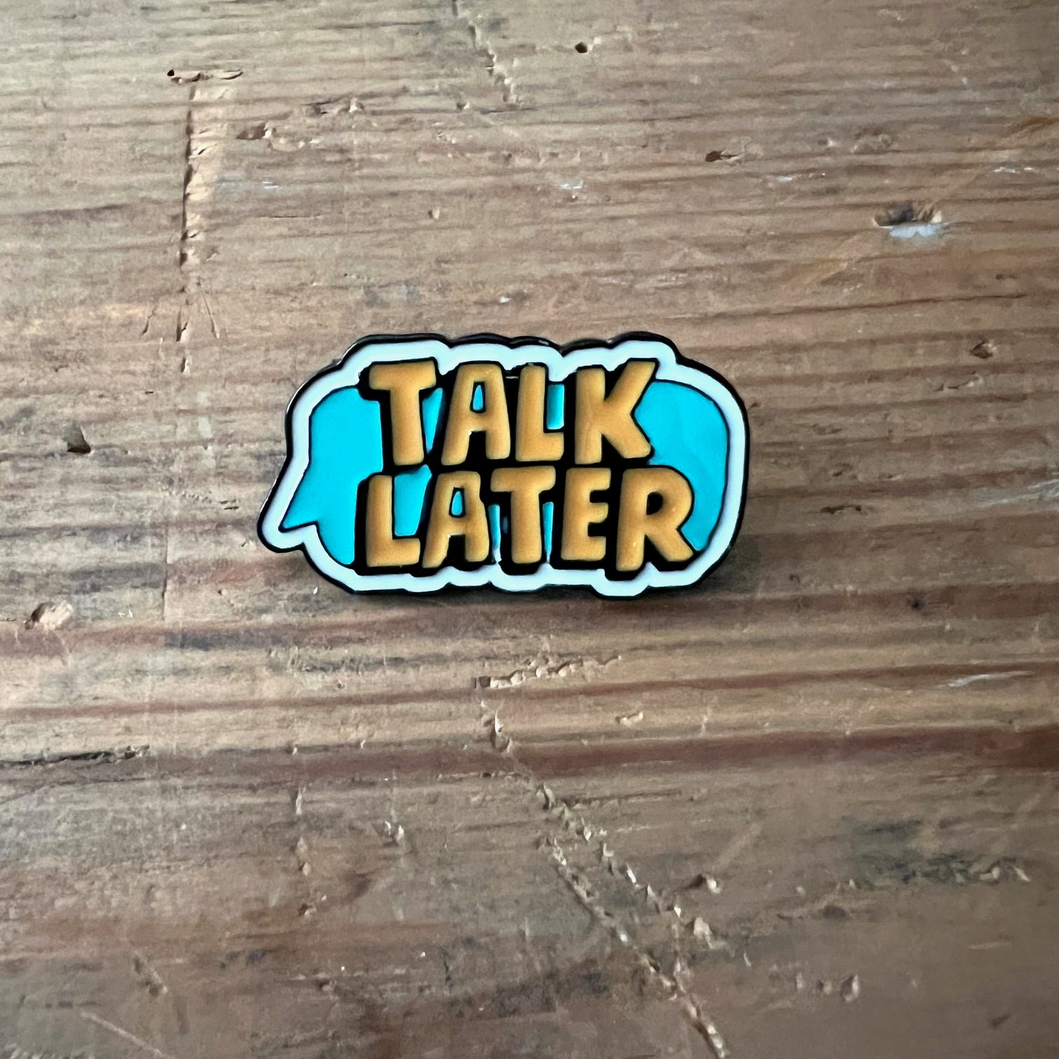 Nyssa "Talk Later" pin featuring a stylish design, perfect for accessorizing bags or clothing with a fun, casual statement.