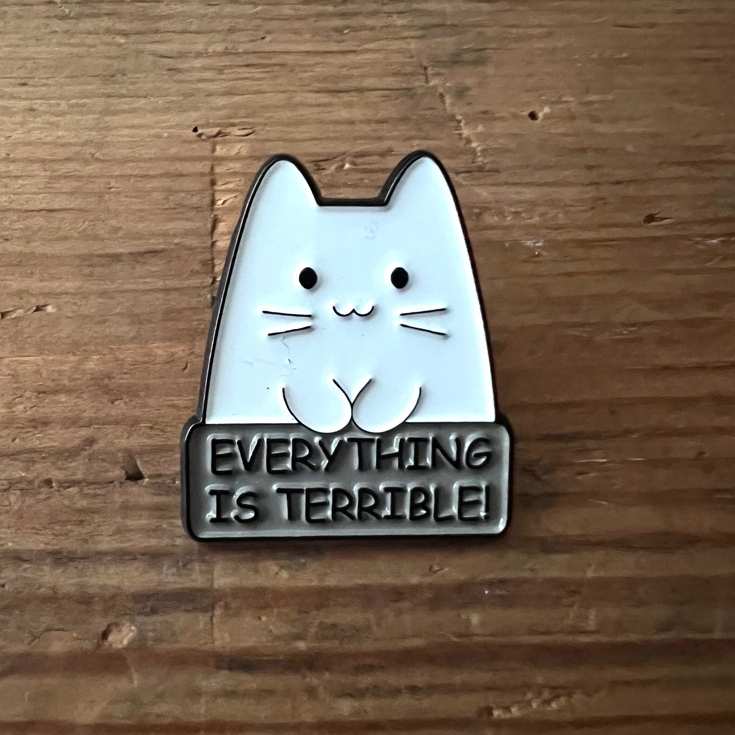 Nyssa "Everything is Terrible" pin featuring bold design, perfect for accessories or collection displays.