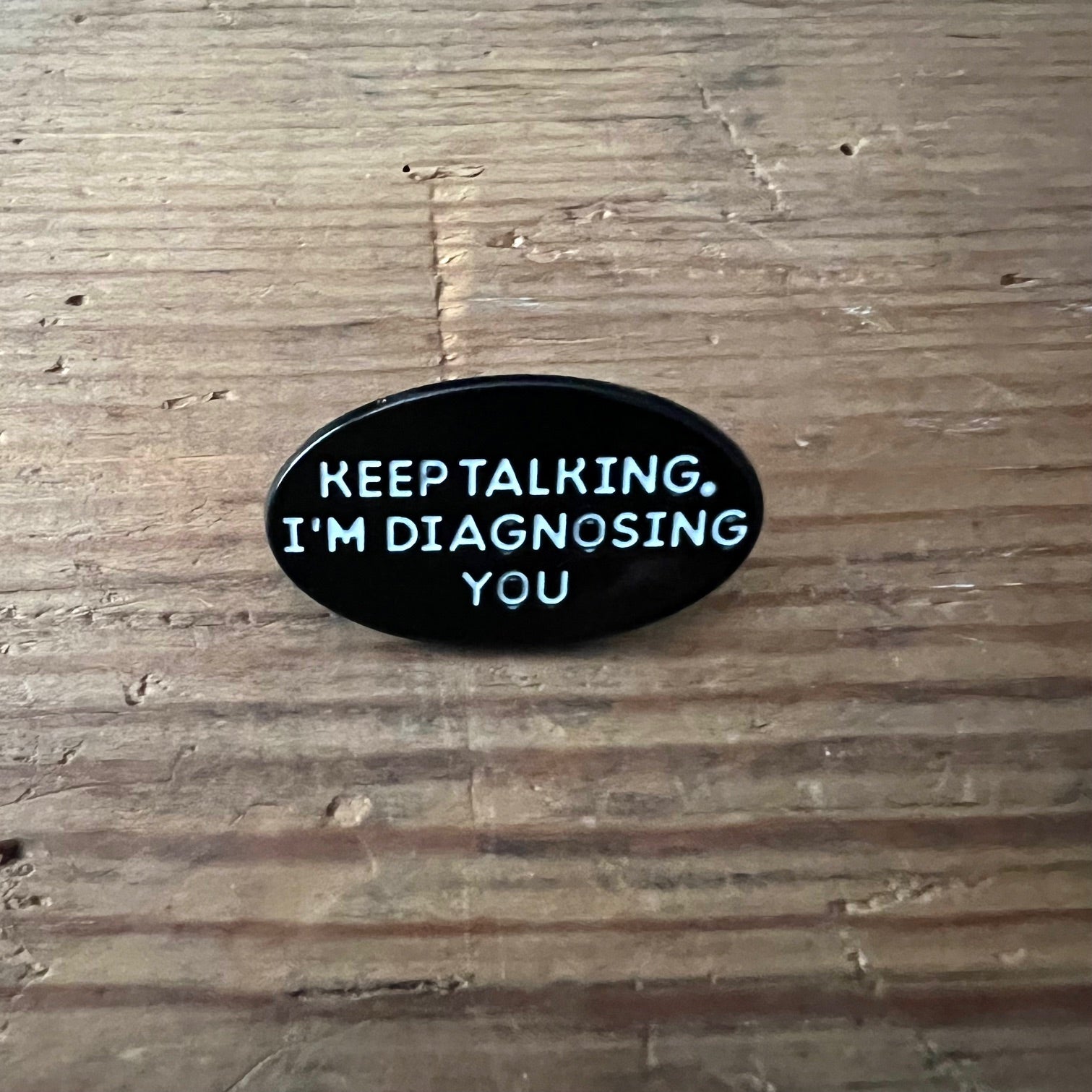 Nyssa "Keep talking, I’m diagnosing you" pin featuring a humorous design, perfect for wearable accessories and conversation starters.