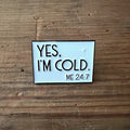 Nyssa "Yes, I’m Cold" pin featuring bold text, designed as a stylish accessory for jackets or backpacks.