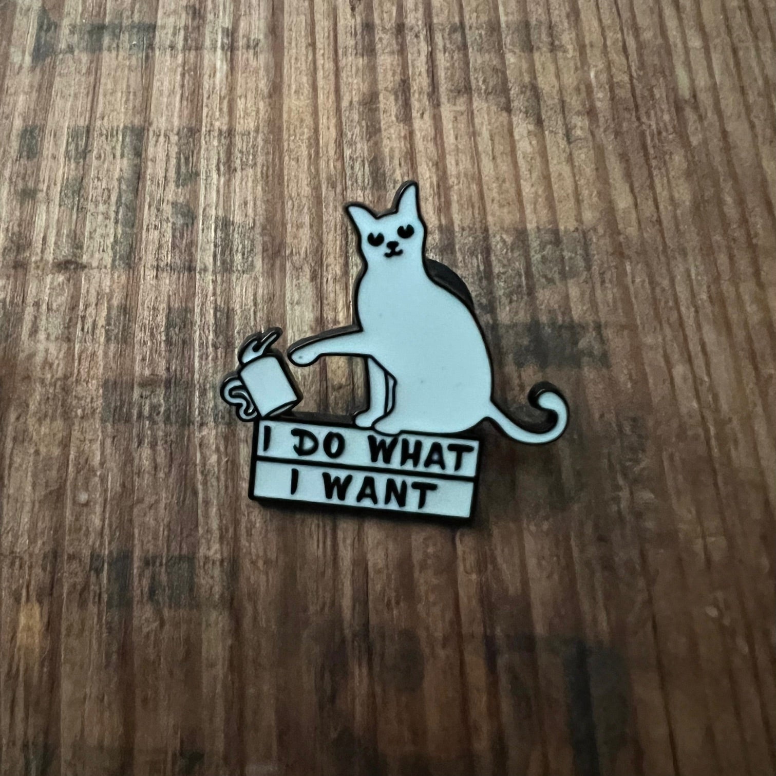 Nyssa "I do what I want" pin featuring bold text on a colorful enamel surface, perfect for accessorizing clothing or bags.