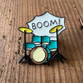 Nyssa BOOM! pin featuring bold, colorful design, perfect for accessorizing bags or clothing with vibrant style.