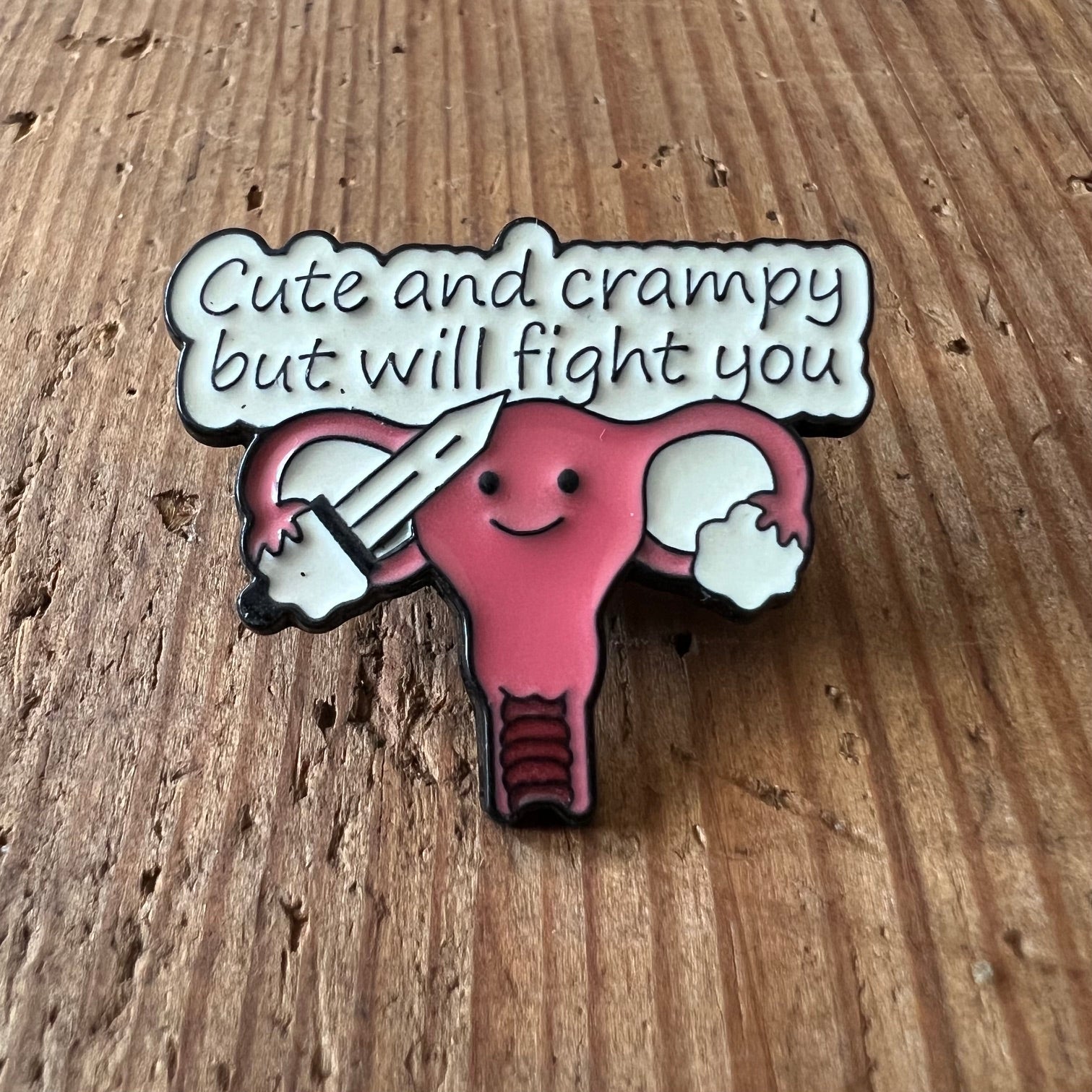 Nyssa Cute and Crampy pin featuring a playful design, showcasing colorful enamel details on a metal pin back.
