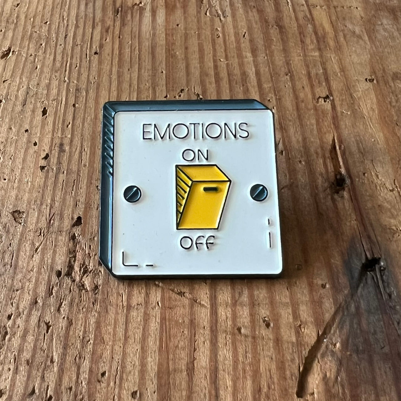 Nyssa Emotion pin featuring a colorful, abstract design on a metal pin back, ideal for accessories or clothing embellishment.