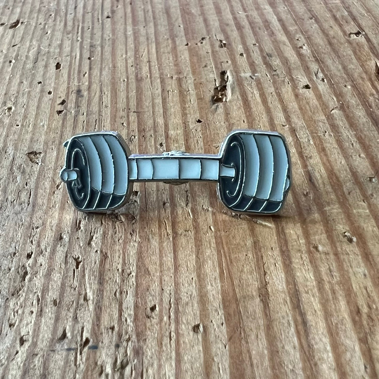 Nyssa Builder Pin showing a small metal decorative pin with the Builder logo, suitable for clothing or accessories.
