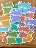 Nyssa Skåneorter sticker featuring colorful illustrated map of Skåne region with city names and landmarks.