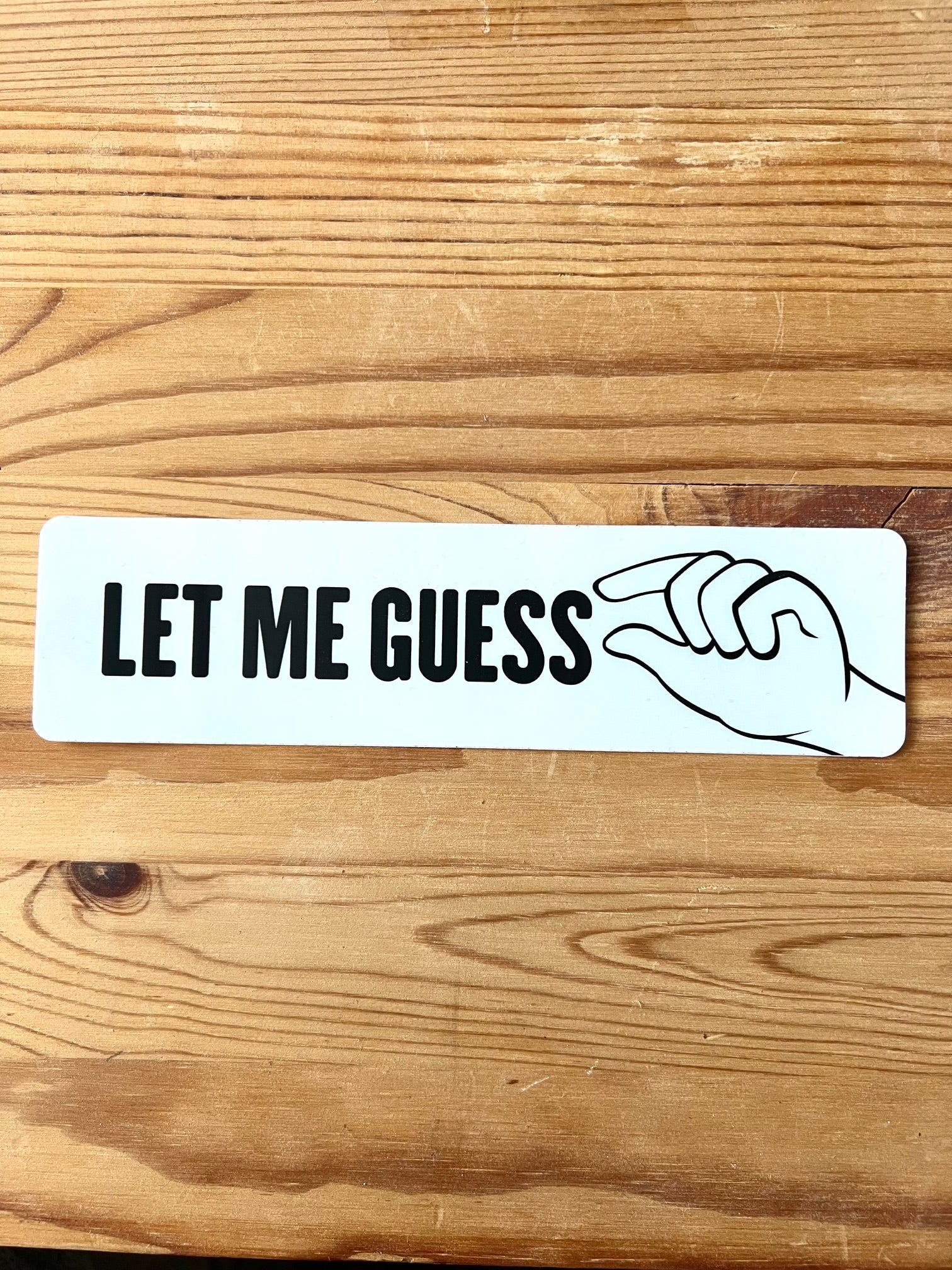 Colorful Nyssa "Let me guess" sticker with bold text and playful design, perfect for decorating laptops or notebooks.