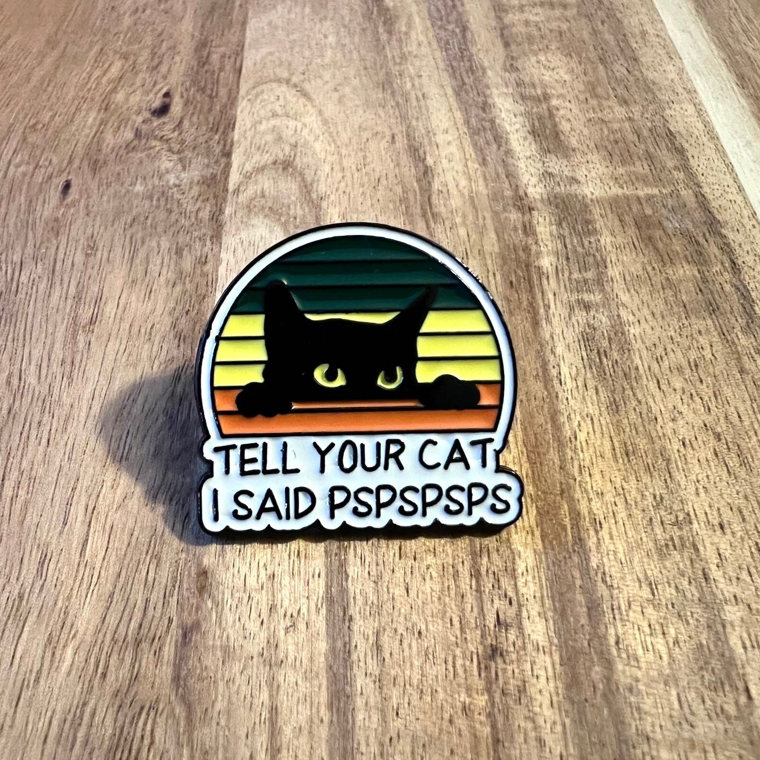 Nyssa "Tell You're Cat..." pin featuring a playful design, perfect for cat lovers and accessories enthusiasts.