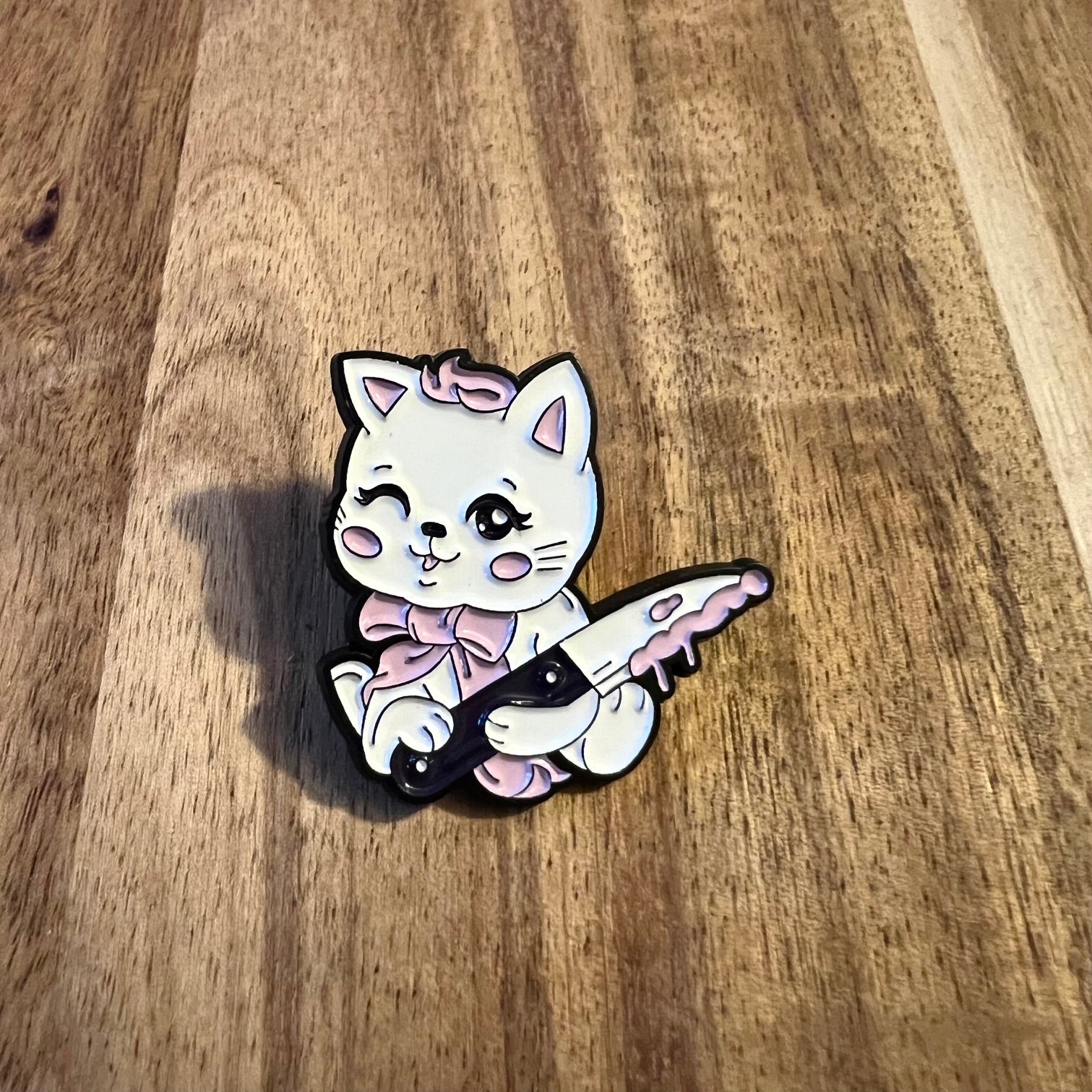 Nyssa KillerCat pin featuring a detailed design, perfect for accessorizing or collecting, shown on a neutral background.