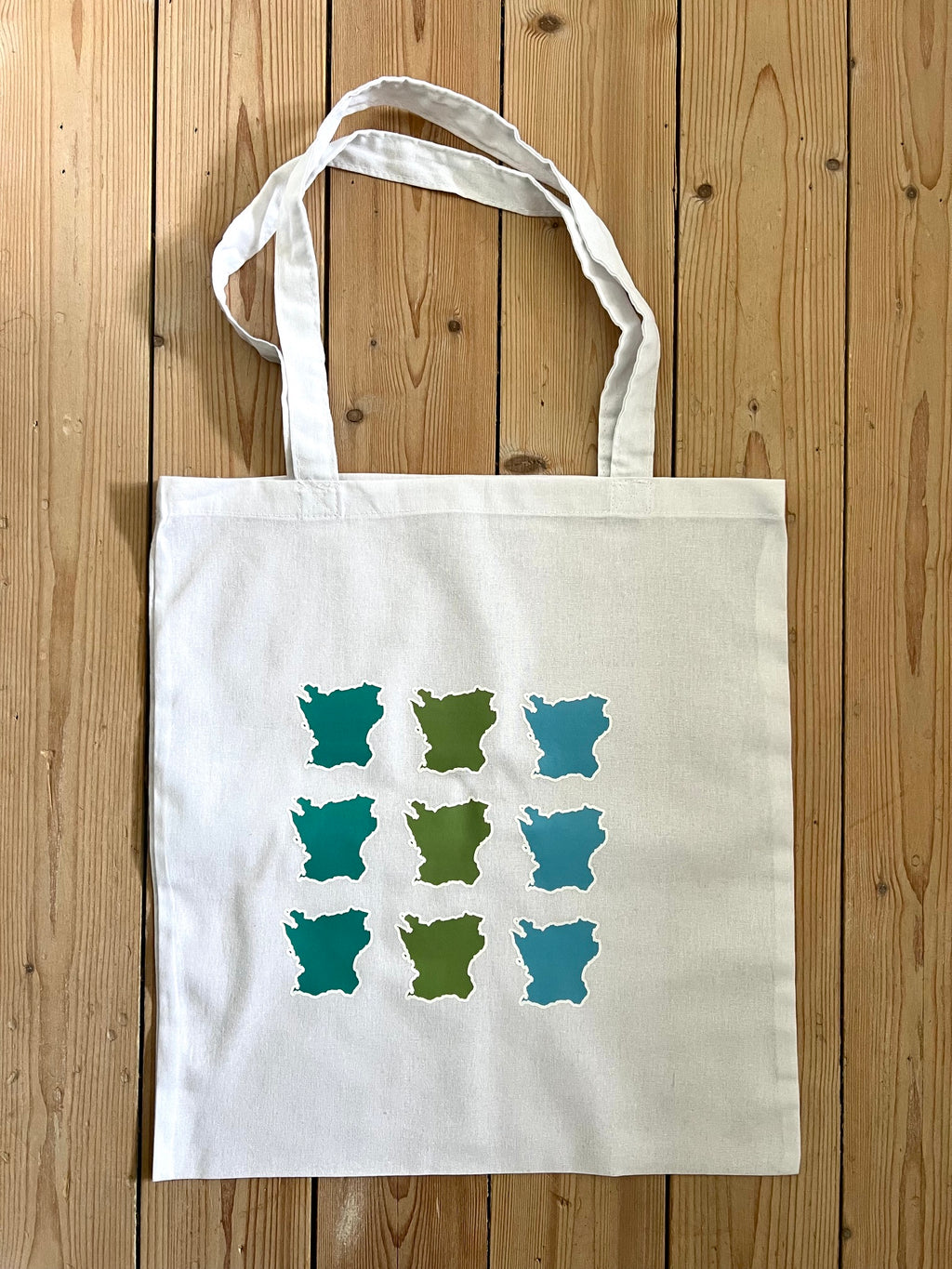 Nyssa Skåne fabric tote bag with handles, showcasing a natural, durable textile design on a white background.