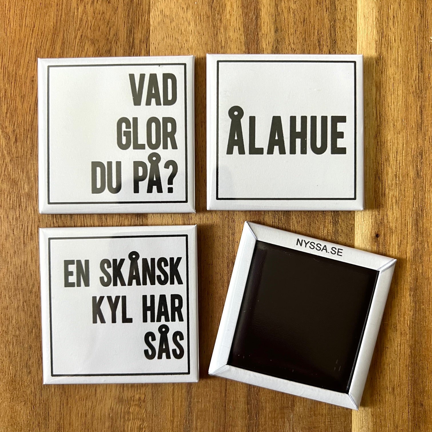 Set of four Nyssa Flabben refrigerator magnets with colorful, playful designs, ideal for decorating or holding notes on a fridge