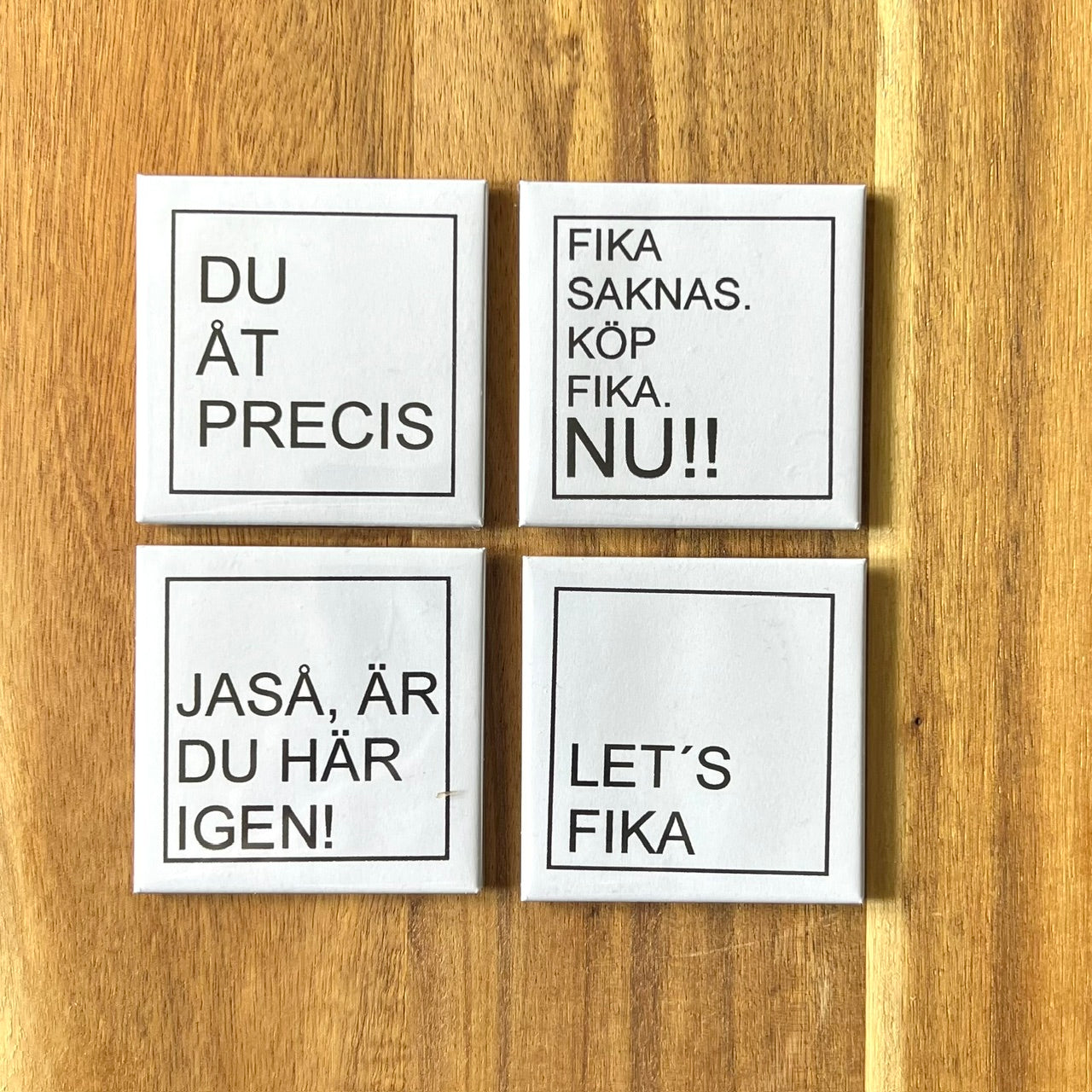 Set of four Nyssa LET'S FIKA fridge magnets with colorful coffee-themed designs on a white background.