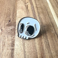 Nyssa skull pin featuring a detailed metallic skull design on a small decorative pin.