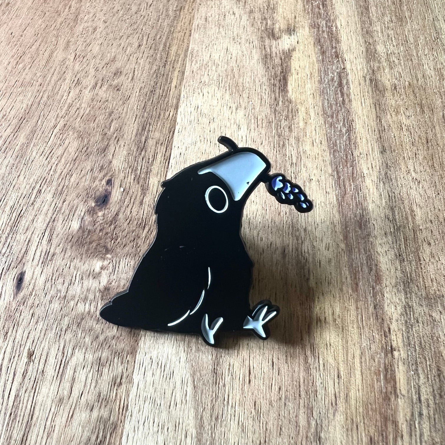 Nyssa Crow pin featuring a detailed metal crow design on a silver-colored pin backing.
