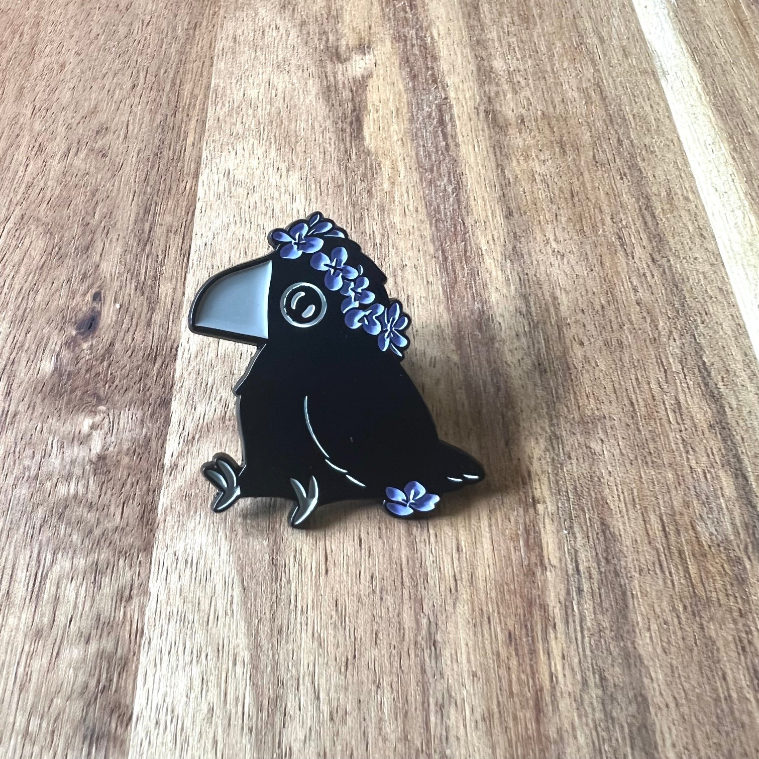 Nyssa Crow pin featuring a detailed metal crow design, perfect for accessories or collectibles.