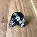 Nyssa Skeleton record pin featuring a detailed skeleton design on a metal pin accessory.