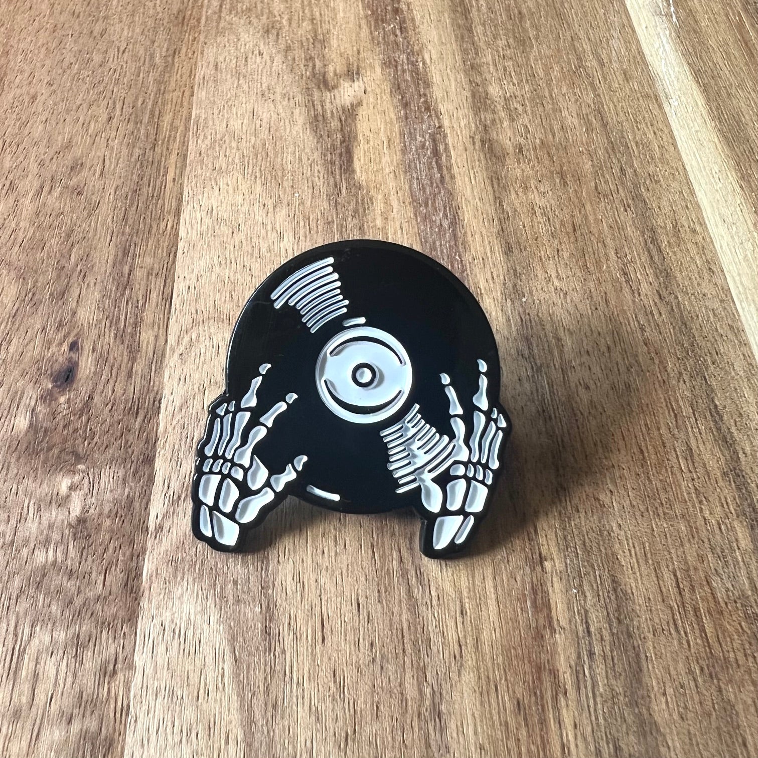 Nyssa Skeleton record pin featuring a detailed skeleton design on a metal pin accessory.